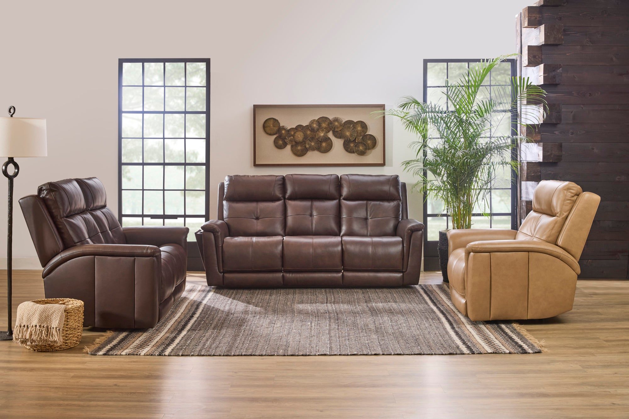 Brown and tan leather power reclining sofa and recliners in a bright living room