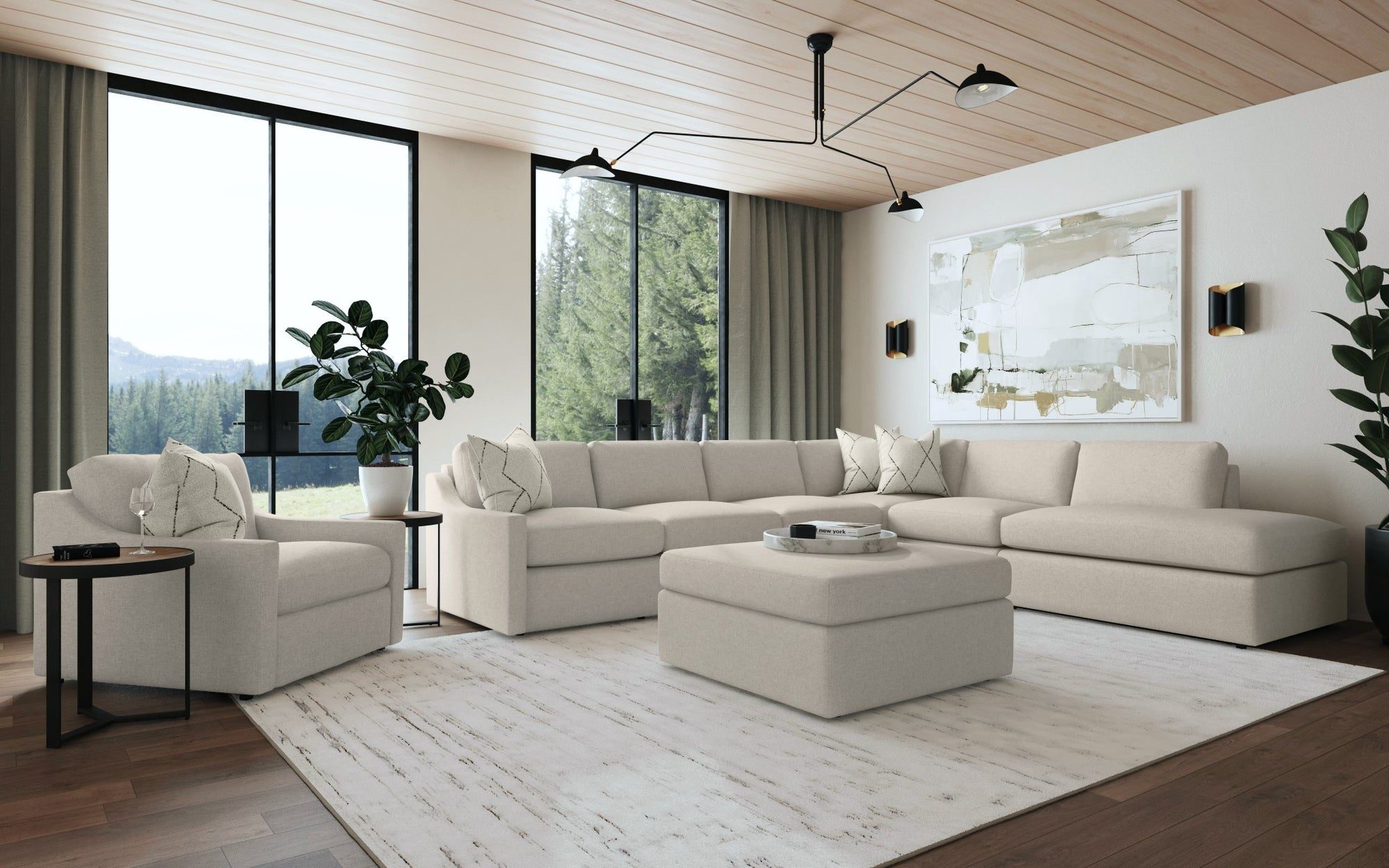 Cream modular sectional, ottoman and chair in a modern living room with tall windows